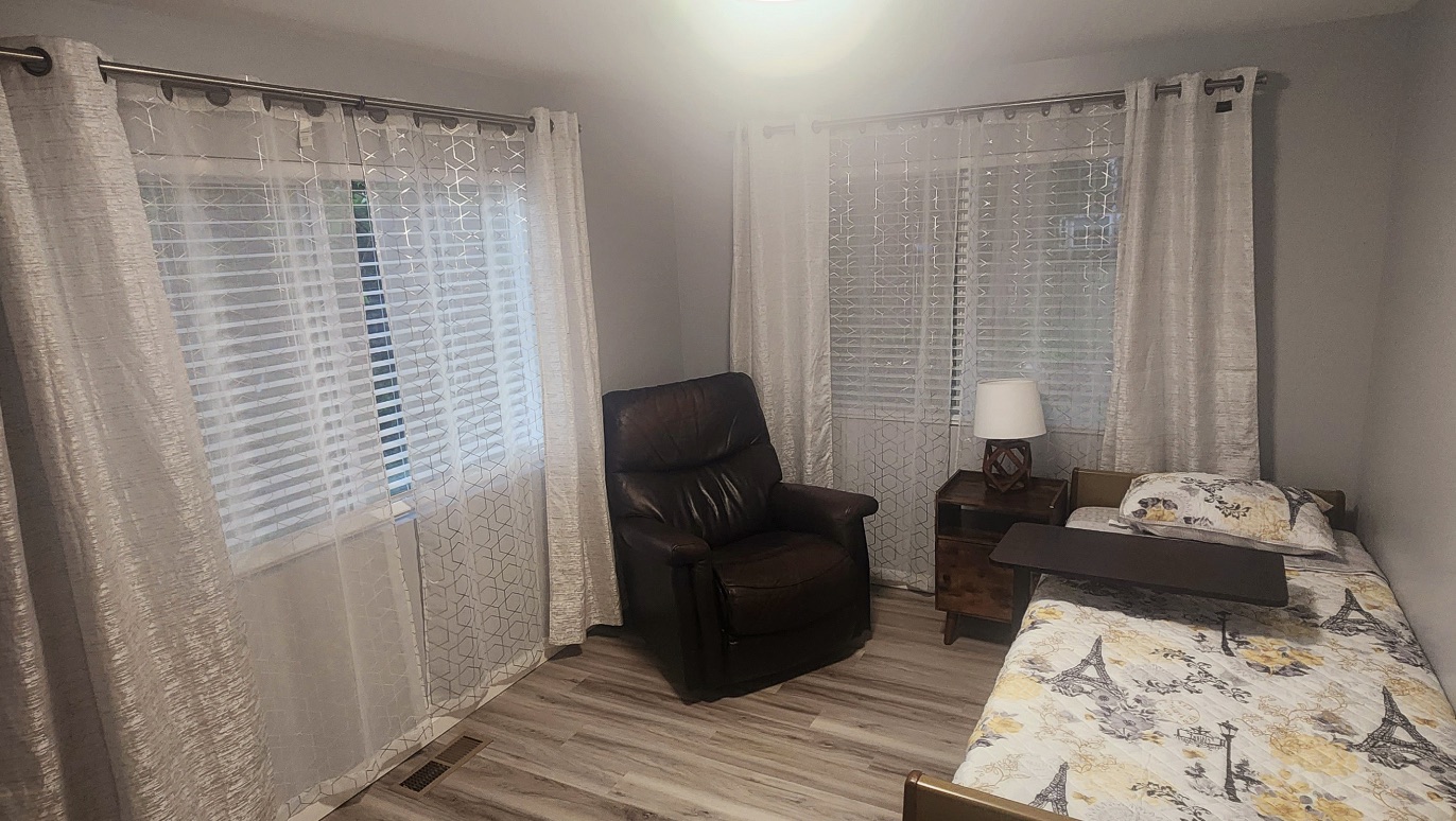 Private bedroom with recliner and windows